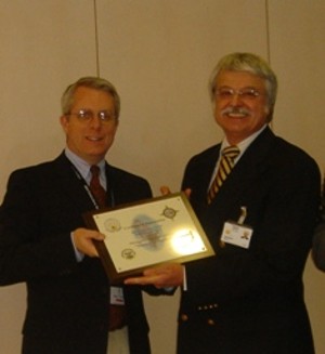 After the IBM tour in December, Roger Carpenter, deputy commander, Defense Information Systems Agency Europe (l), presents a plaque to Rainer Strobach, one of the IBM tour guides, as a token of appreciation.